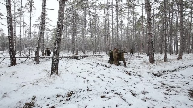 Infantrymen with weapons in their hands - in the forest. Camouflage