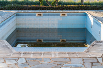 empty and dirty blue ceramic pool