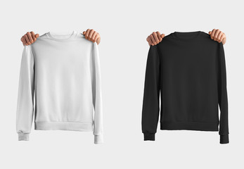 Template fashionable pullover with hands holding clothes, a white and black sweatshirt, isolated on...