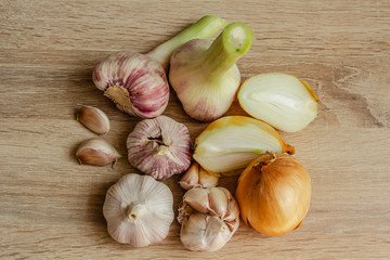 healthy vegetables: onions and garlic on wooden background close-up