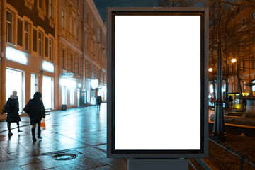 Vertical billboard in the city at night. Advertising luminous billboard