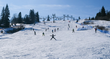 snowy ski slope full of skiers and snowboarders © Wojciech