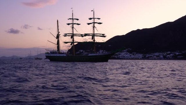 Rippling blue water surface. Sailing ship floating in Mediterranean sea. Lipari Islands, Sicily, Italy