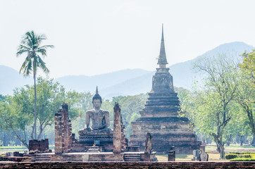 Conical stupa and seated Buddha, Sukhothai Historical Park, Thailand