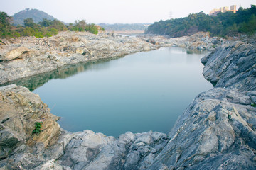 a river flowing between the rocks downhill
