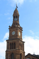 Fototapeta na wymiar Sydney Town Hall Clock tower with a blue sky back ground. Richly decorated nineteenth century high victorian sandstone building. Second Empire Style architecture. Australia