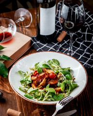 fried potatoes with fresh vegetables and red wine