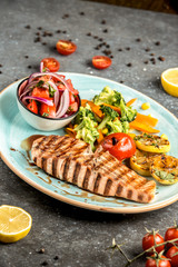 fried salmon with vegetables on the table ___