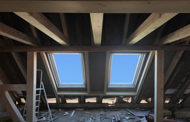 Replacing 2 plastic skylight windows with new one in mansard garret,or attic,of old private...