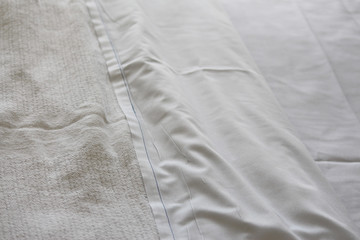 Close up of fresh white hospital sheet and blanket