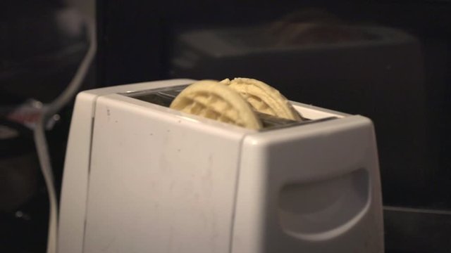 Hot Waffles Popping Out Of An Oven Toaster In The Kitchen - Closeup Shot