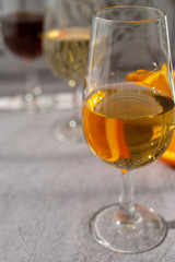 Glass with cold fino sherry fortified wine in sunlights, andalusian style interior on background