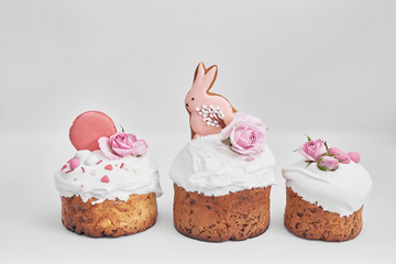 Easter orthodox sweet bread, Easter cake with flowers and gingerbread. Holidays breakfast concept with copy space. Easter greeting card template. Homemade pasques.Easter sweets on white background.