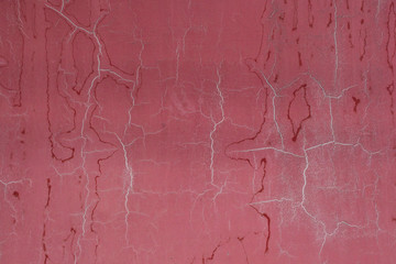 Abstract faded red background texture with cracks on old paint