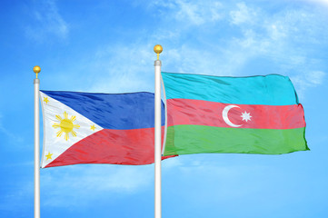 Philippines and Azerbaijan two flags on flagpoles and blue cloudy sky
