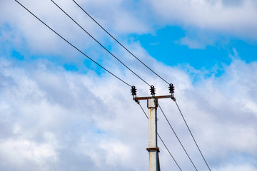 Electric pole against the sky, electric cable.
