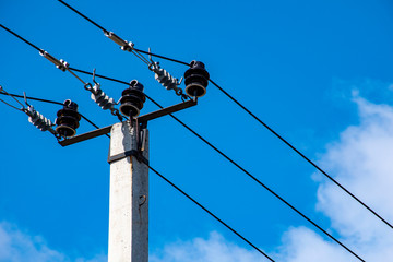 Electric pole against the sky, electric cable.