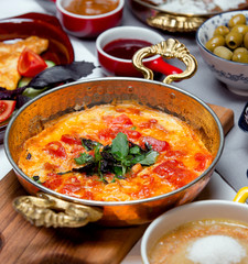 fried tomatoes with eggs on the table