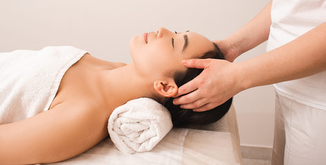relaxing anti-stress head massage. Beautiful woman relaxes in a massage parlor during a massage