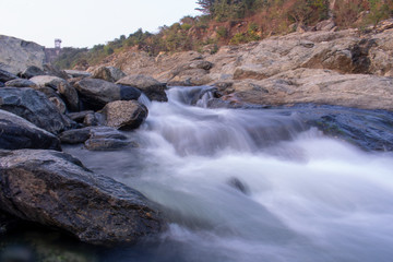 beautiful long exposure stock image of water flowing down the hill