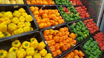 Red, yellow and green bell peppers in the market