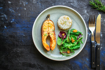 pink salmon steak fried and salad,
grilled seafood, pescatarian Menu concept food background keto or paleo diet. top view. copy space for text