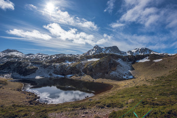 Laguna de Almagrera o Laguna de la Mina at the end of winter. Saliencia lakes in the Somiedo Nature Park, Asturias, Spain. Snowy areas in the mountains.