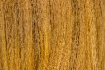 Naklejka premium Red hair texture, close up. Hair pattern on a red background.