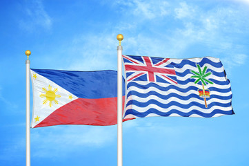 Philippines and British Indian Territory two flags on flagpoles and blue cloudy sky
