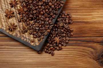 Coffee beans and stars anise on a wooden background. Top view .