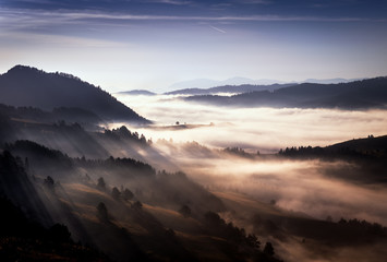 Beautiful, colorful autumn panorama of Pieniny Mountains (Male Pieniny) in the fog and morning light .
Poland, Slovakia.