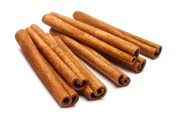 Bunch of delicious cinnamon sticks, isolated on white background
