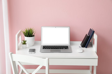 Fototapeta premium Modern laptop on workplace in room