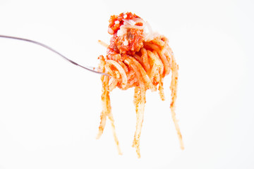 Spaghetti bolognese sprinkled with cheese on a fork on a white background