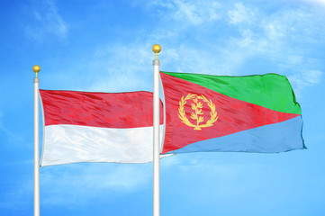 Naklejka na ściany i meble Indonesia and Eritrea two flags on flagpoles and blue cloudy sky