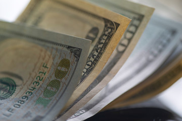A scattered bundle of hundred dollar bills.