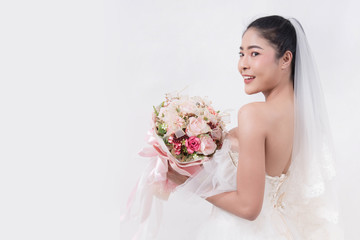 Naklejka premium Asian woman is wearing wedding dress with free space on white background