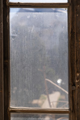 old wooden window with dirty glass