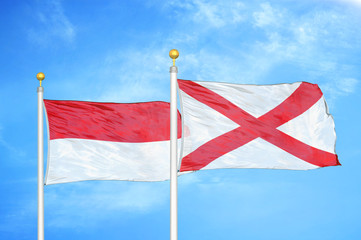 Indonesia and Northern Ireland two flags on flagpoles and blue cloudy sky