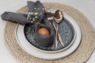 Easter table setting with linen napkin and ceramic tableware