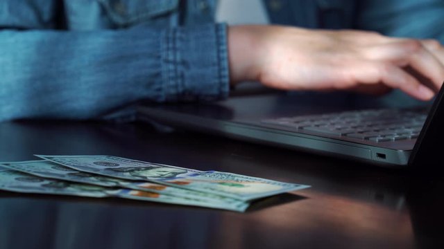 Businessman paying salary in cash to office worker