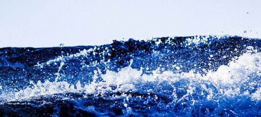 Close-up Of Water Splashing Against Clear Blue Sky