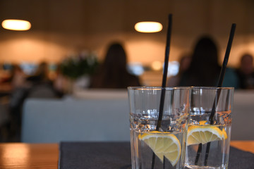 Water with lemon, drink, cocktail on the table in cafe with beautiful blurred background