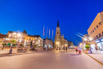 Deurstickers Novi Sad, Serbia - July 19, 2019: Freedom Square (serbian: Trg slobode) is the main square in Novi Sad. There is a cathedral (The Name of Mary Church, Roman Catholic parish church) in the square. © nedomacki