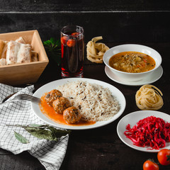 noodle soup and rice with meatballs