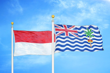 Indonesia and British Indian Territory two flags on flagpoles and blue cloudy sky