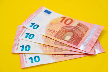 Euro banknotes on a yellow background. Copy, empty space for text