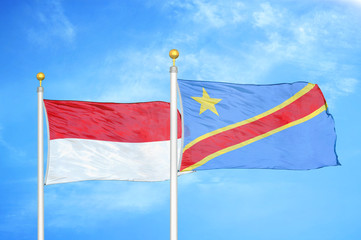 Indonesia and Congo Democratic Republic two flags on flagpoles and blue cloudy sky