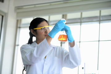 Scientists working in laboratory,Young women scientists are experimenting with science at the lab.Asian scientist holding a test tube in a laboratory	