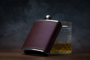 Leather Hip Flask resting on glass of whiskey